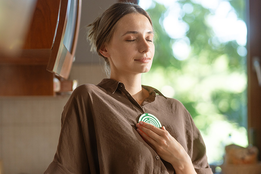A woman holding an AGAPE antenna against her chest A woman holding an AGAPE antenna against her chest